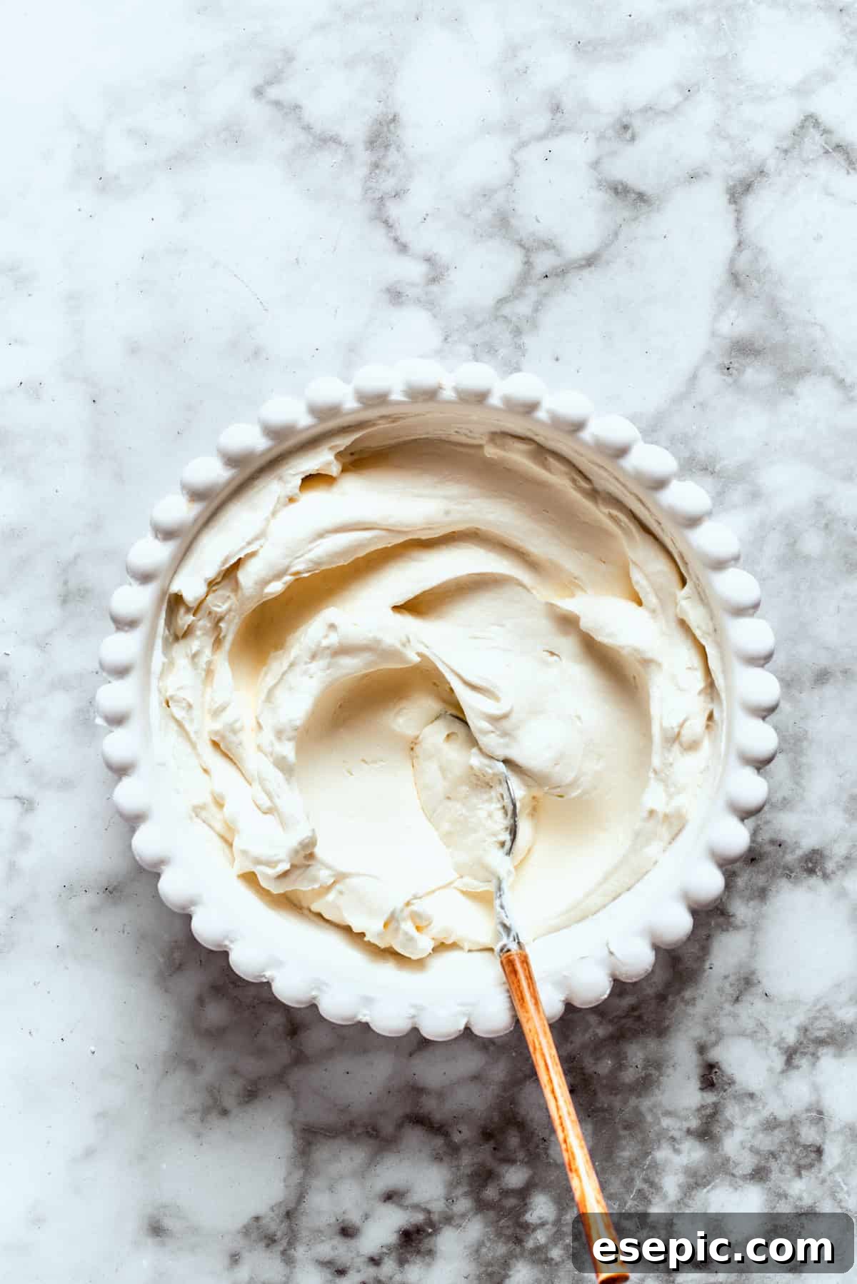 The cream cheese layer is mixed in a bowl.