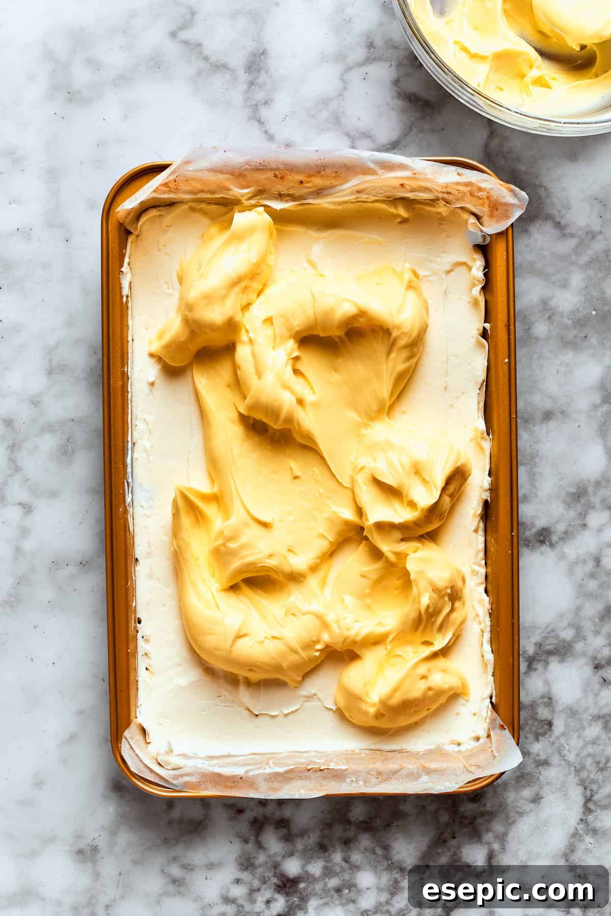 The thick vanilla pudding layer is carefully spread over the cream cheese layer.