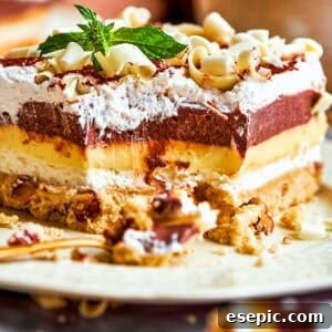 A side view of sex in a pan dessert with all the layers showing.