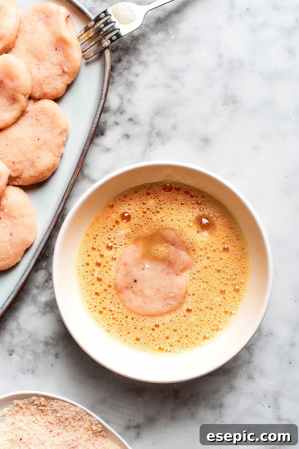 This easy homemade Chicken Nuggets Recipe features perfectly cooked homemade chicken nuggets that are crispy outside and juicy on the inside. Chicken is dipped in egg.