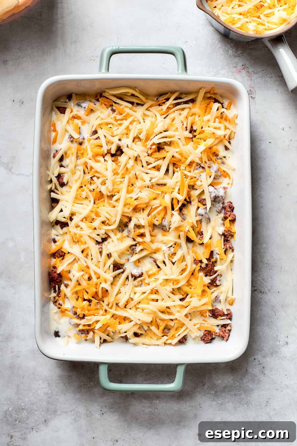 Cheese is added to the meat layer.