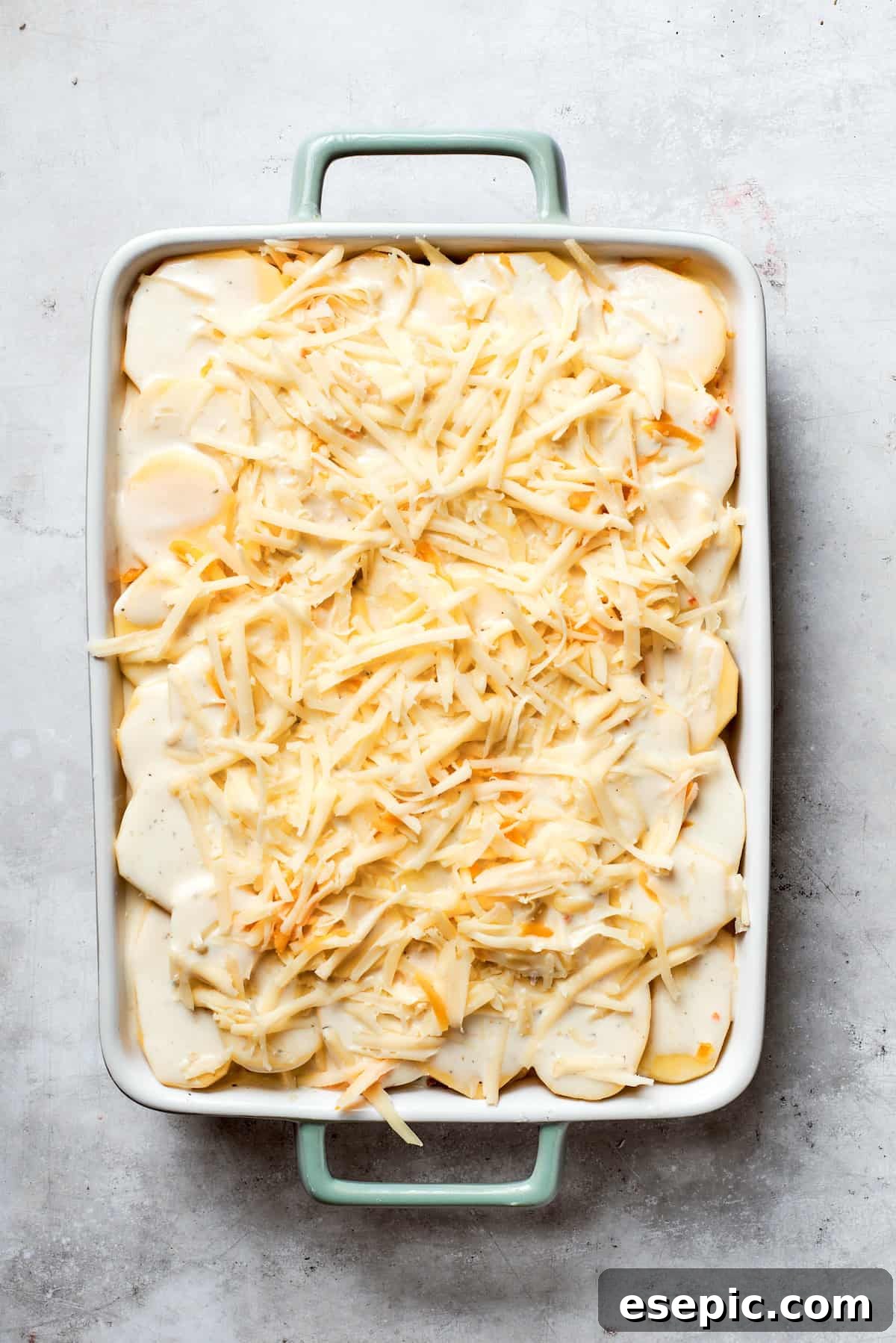 Cheese is added to the top of the casserole,