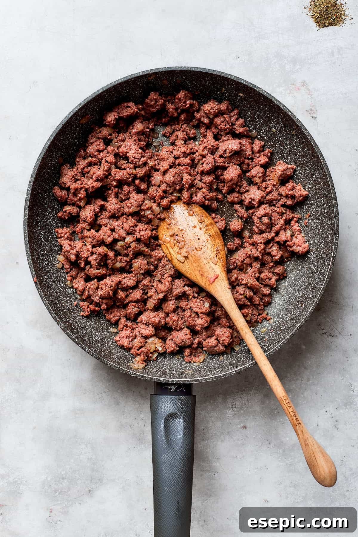 The beef is browned in a skillet.
