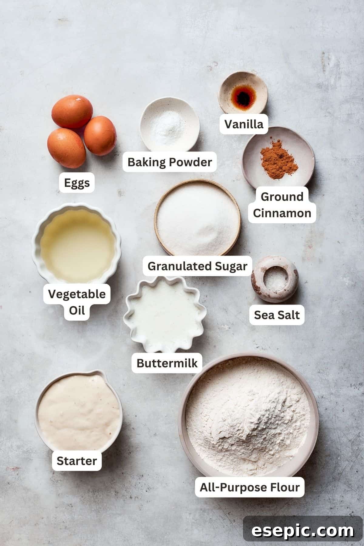 Amish friendship bread ingredients: flour, sugar, baking powder, eggs, cinnamon, salt, buttermilk, vanilla, starter.