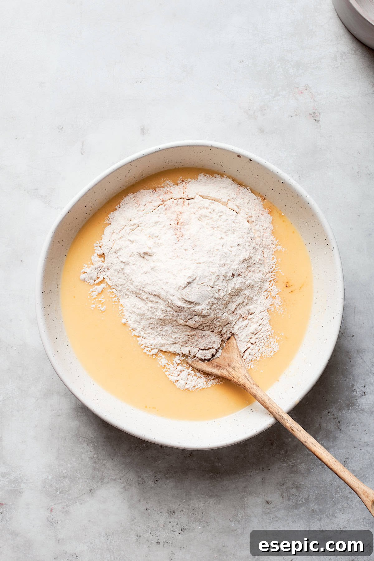 Flour is stirred into the batter.