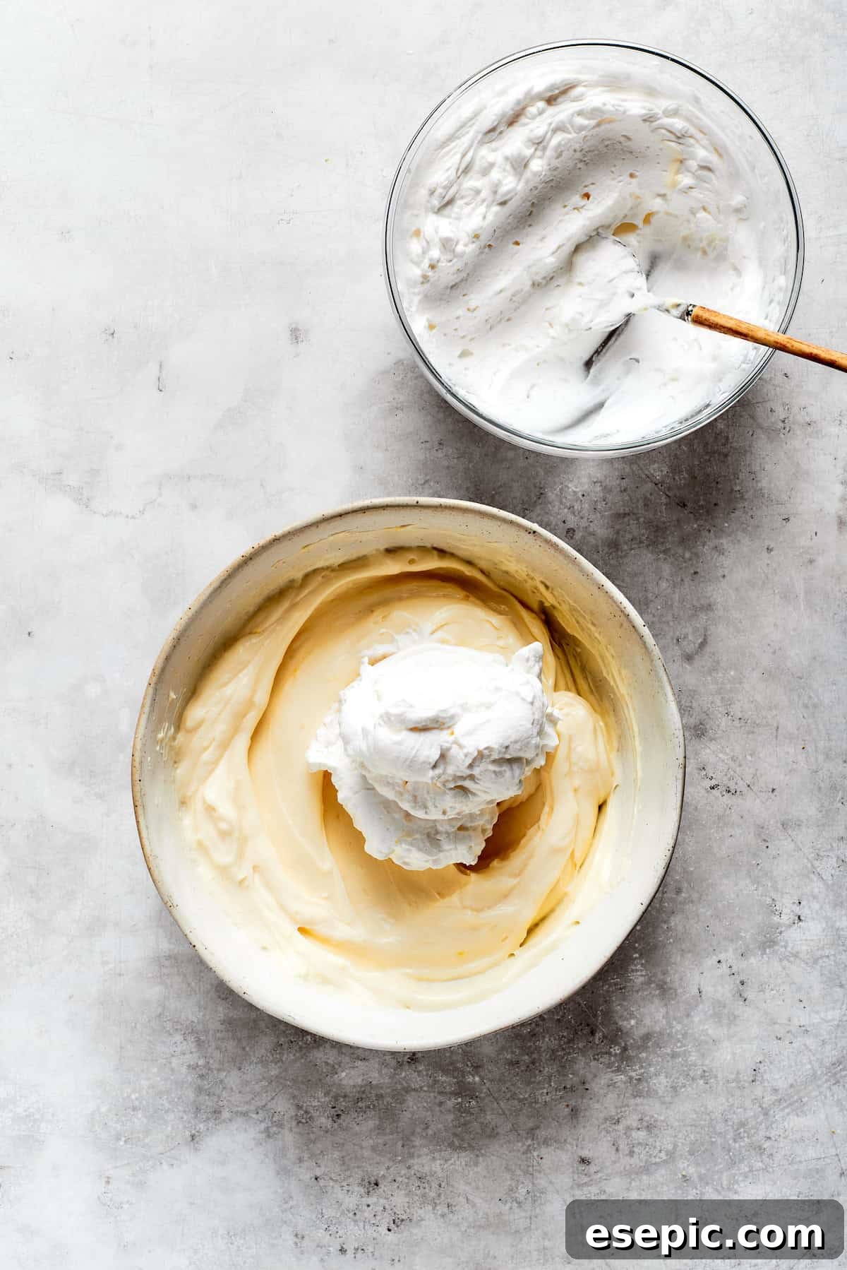 Fluffy whipped cream is gently folded into the mascarpone mixture to create a light and airy filling.