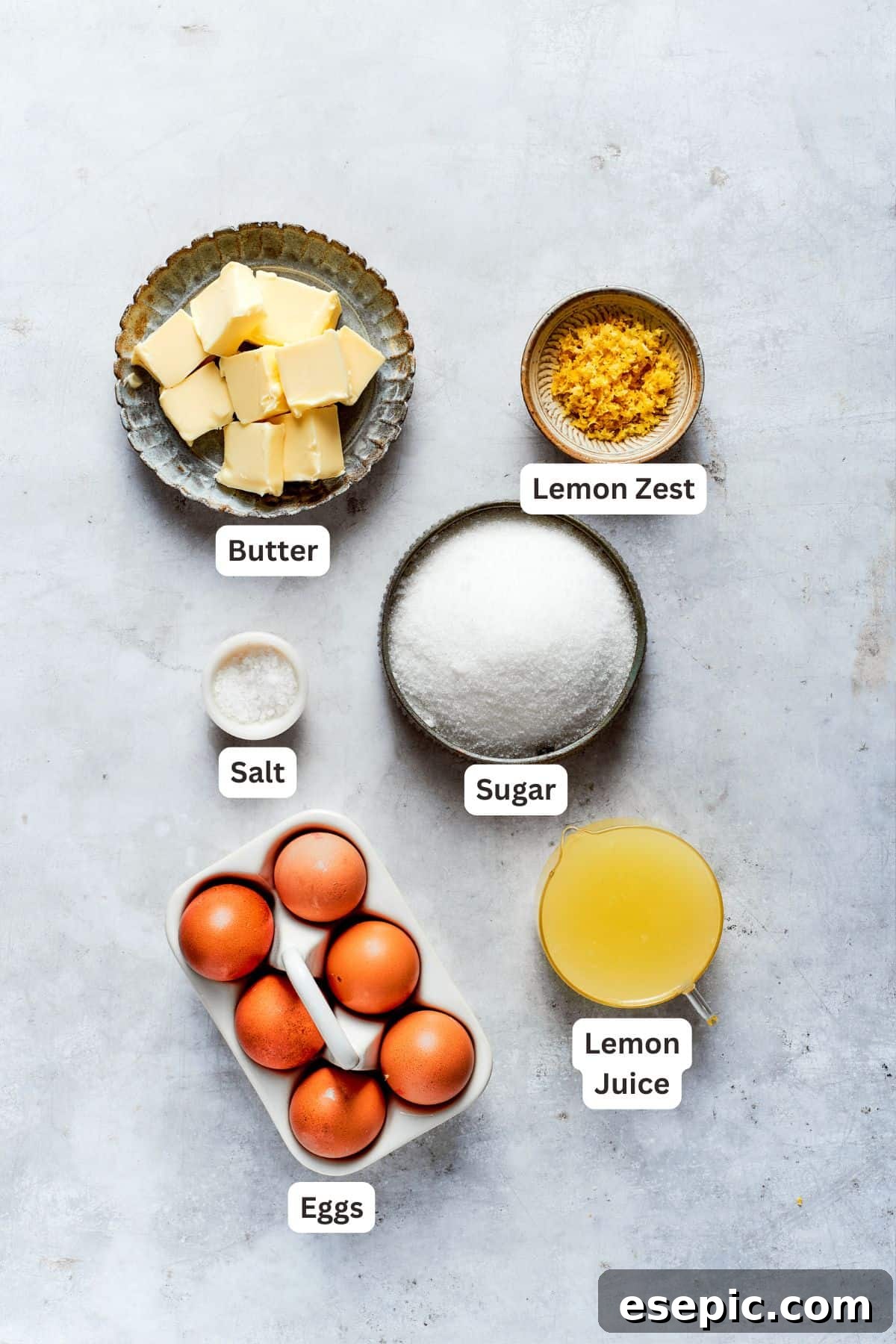 Lemon curd ingredients: unsalted butter, large eggs, granulated sugar, fresh lemon juice, and lemon zest, along with a pinch of salt.