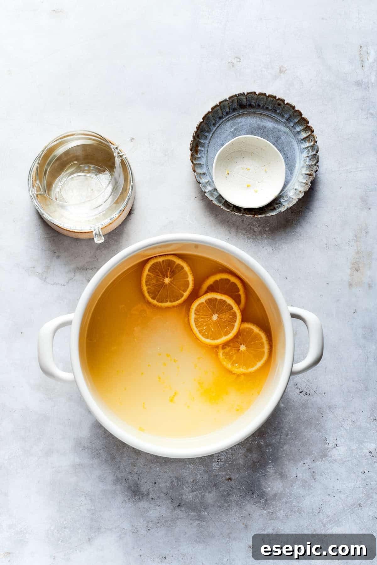 Making lemon syrup in a pot on the stove, with ingredients gently simmering.