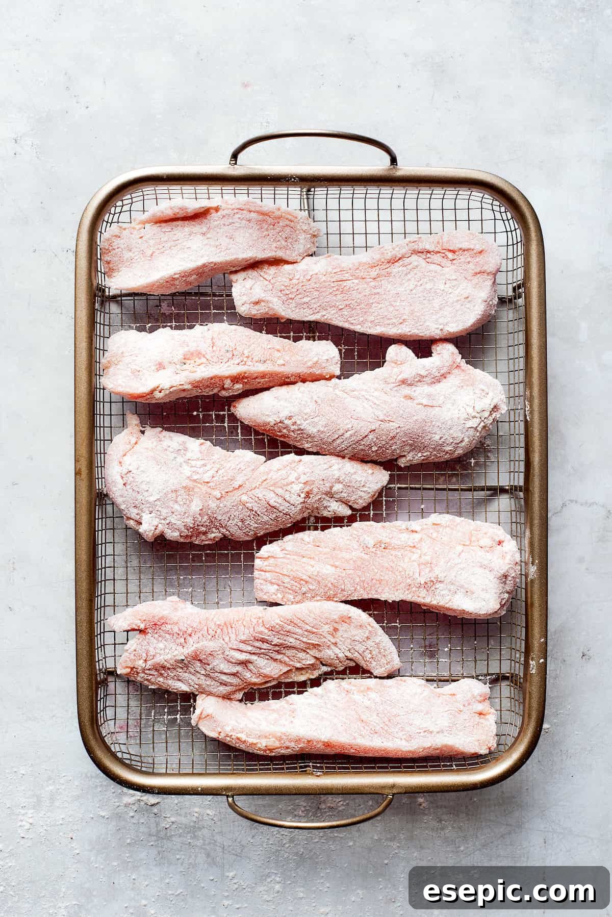Pieces of chicken on a wire rack.