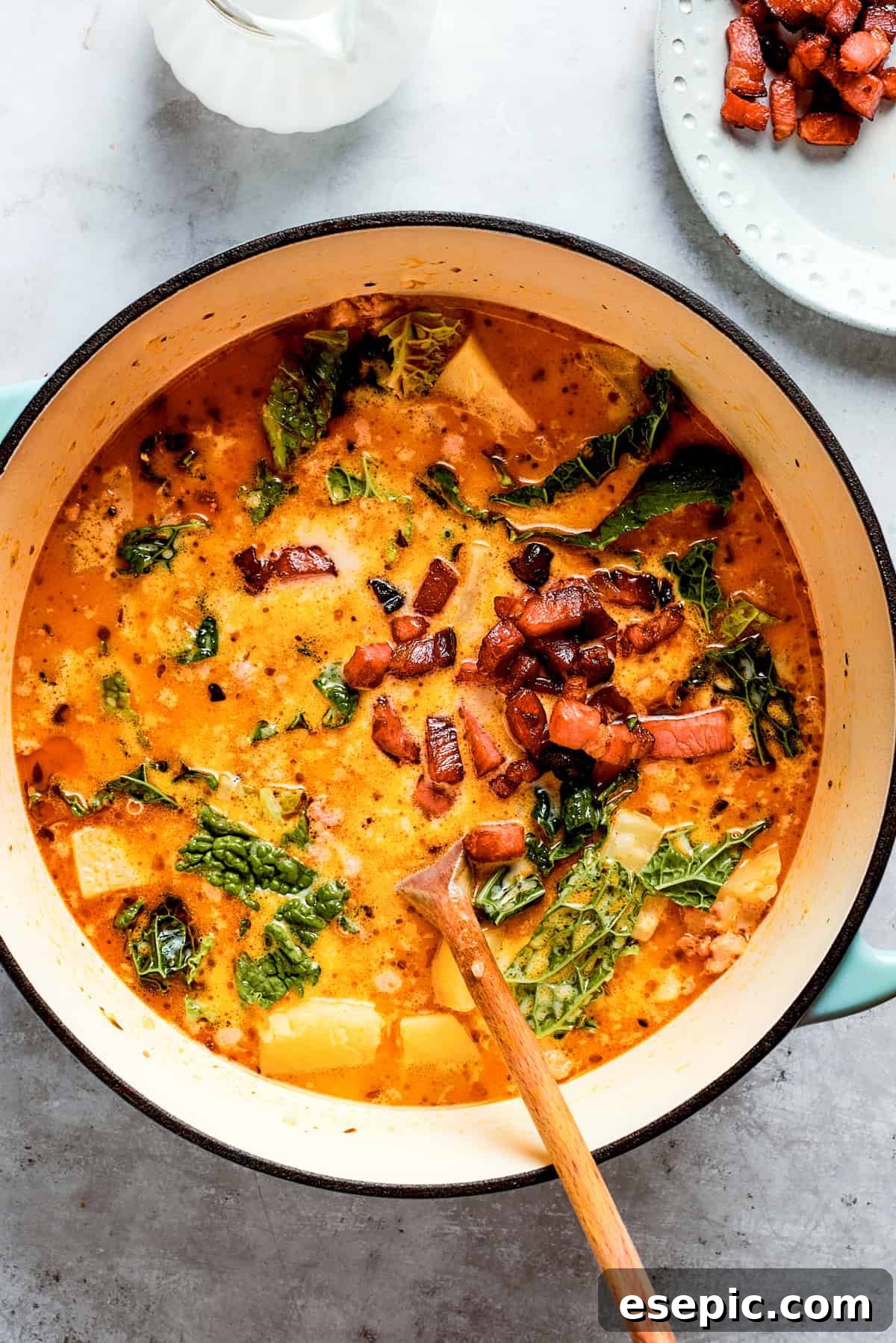 Overhead shot of rich, creamy Zuppa Toscana simmering in a pot, ready to be served.