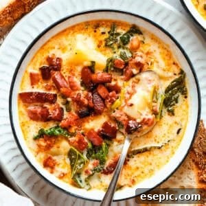 A bowl of Zuppa Toscana served in a bowl and garnished with crumbled bacon.