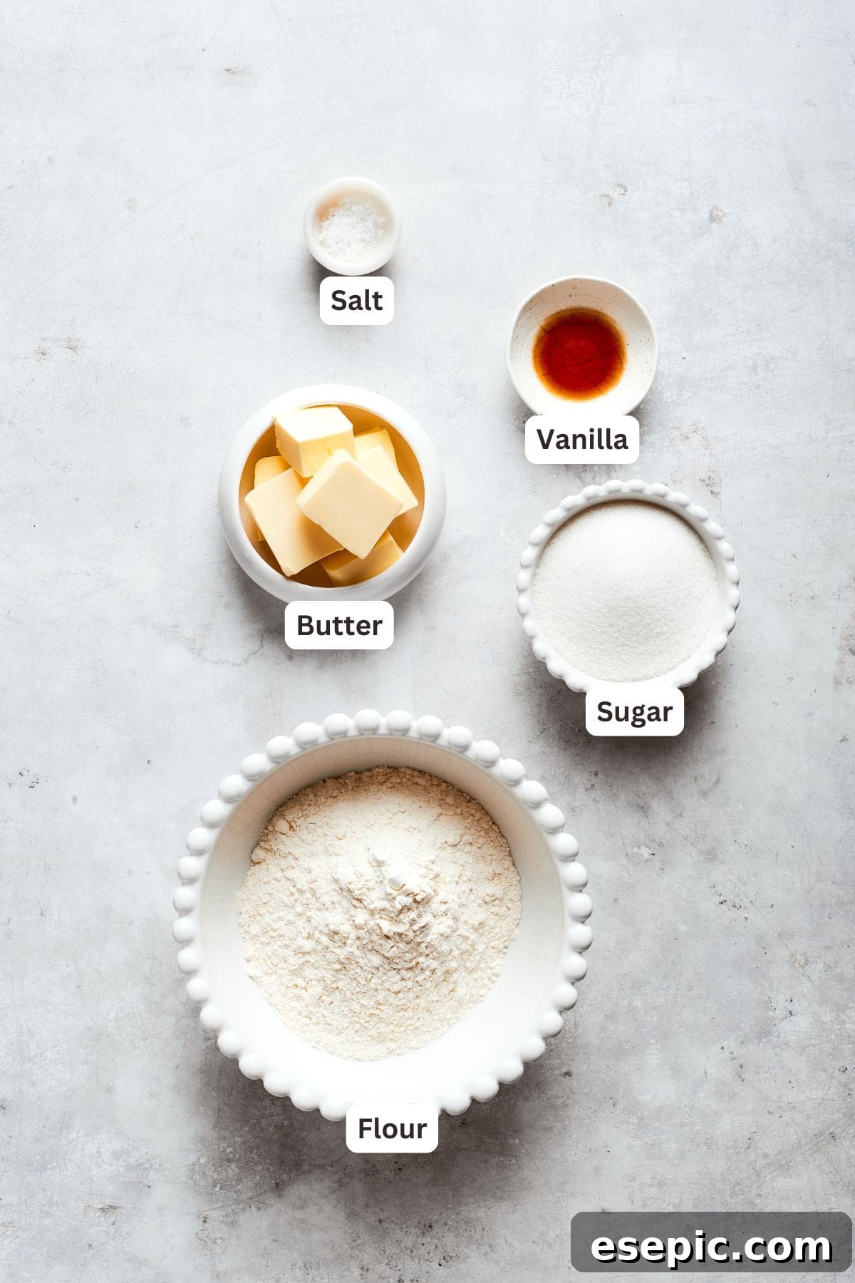 Millionaire Bars are decadent layers of homemade buttery shortbread, creamy caramel, and thick chocolate ganache. Labeled ingredients for the shortbread layer: butter, sugar, vanilla extract, salt, all-purpose flour.