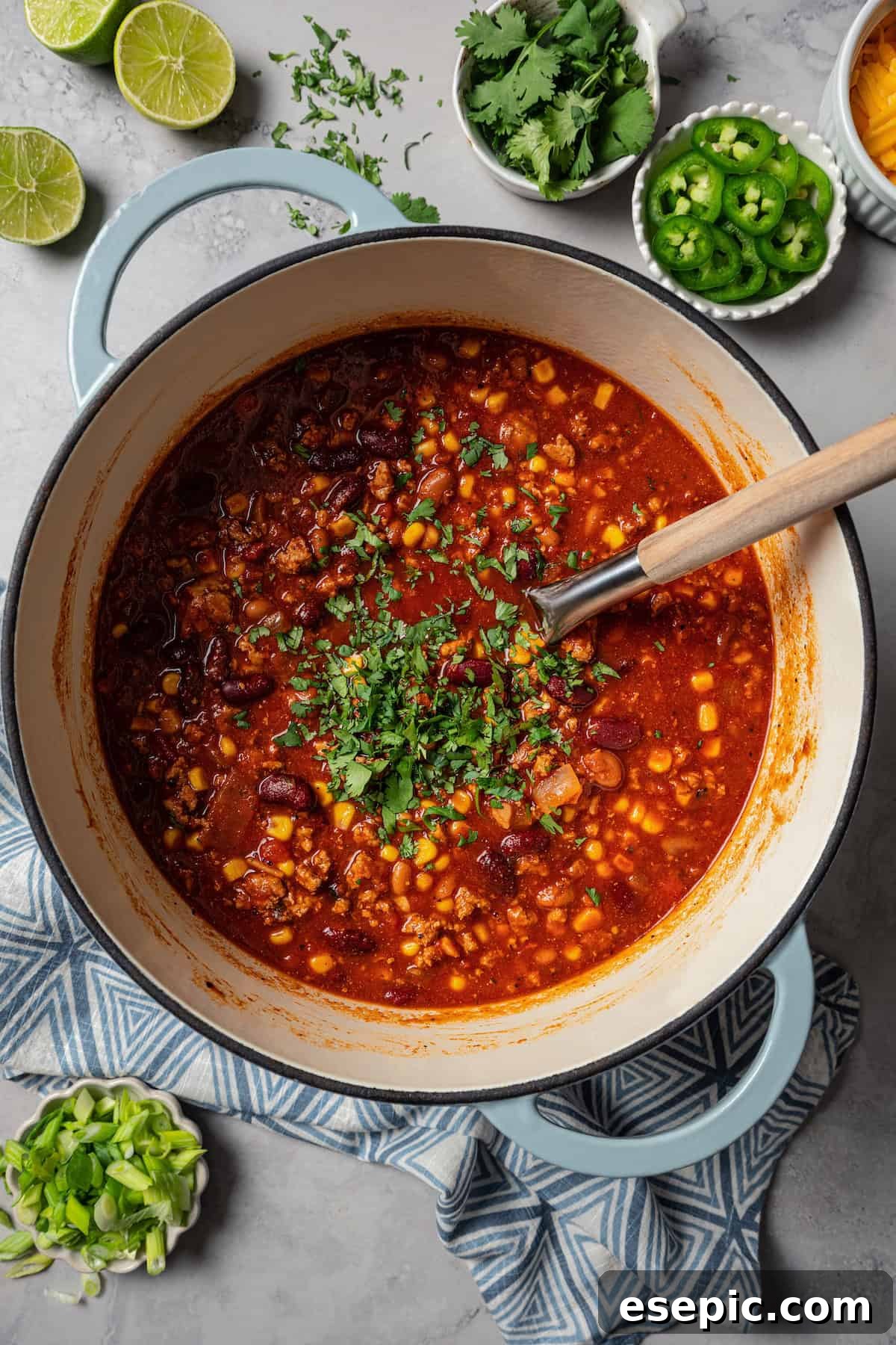 Finished turkey chili garnished with cilantro in a large pot.