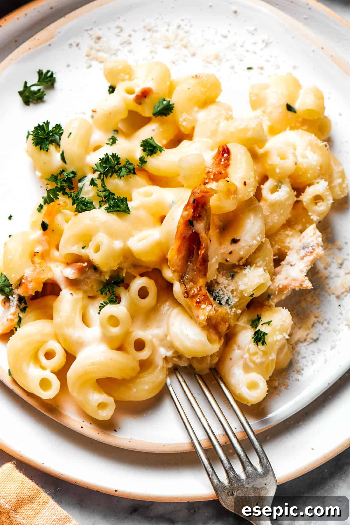 Creamy Garlic Parmesan Chicken Pasta 14 Garlic parmesan chicken pasta served generously on a dinner plate, garnished with fresh herbs, ready to be eaten.