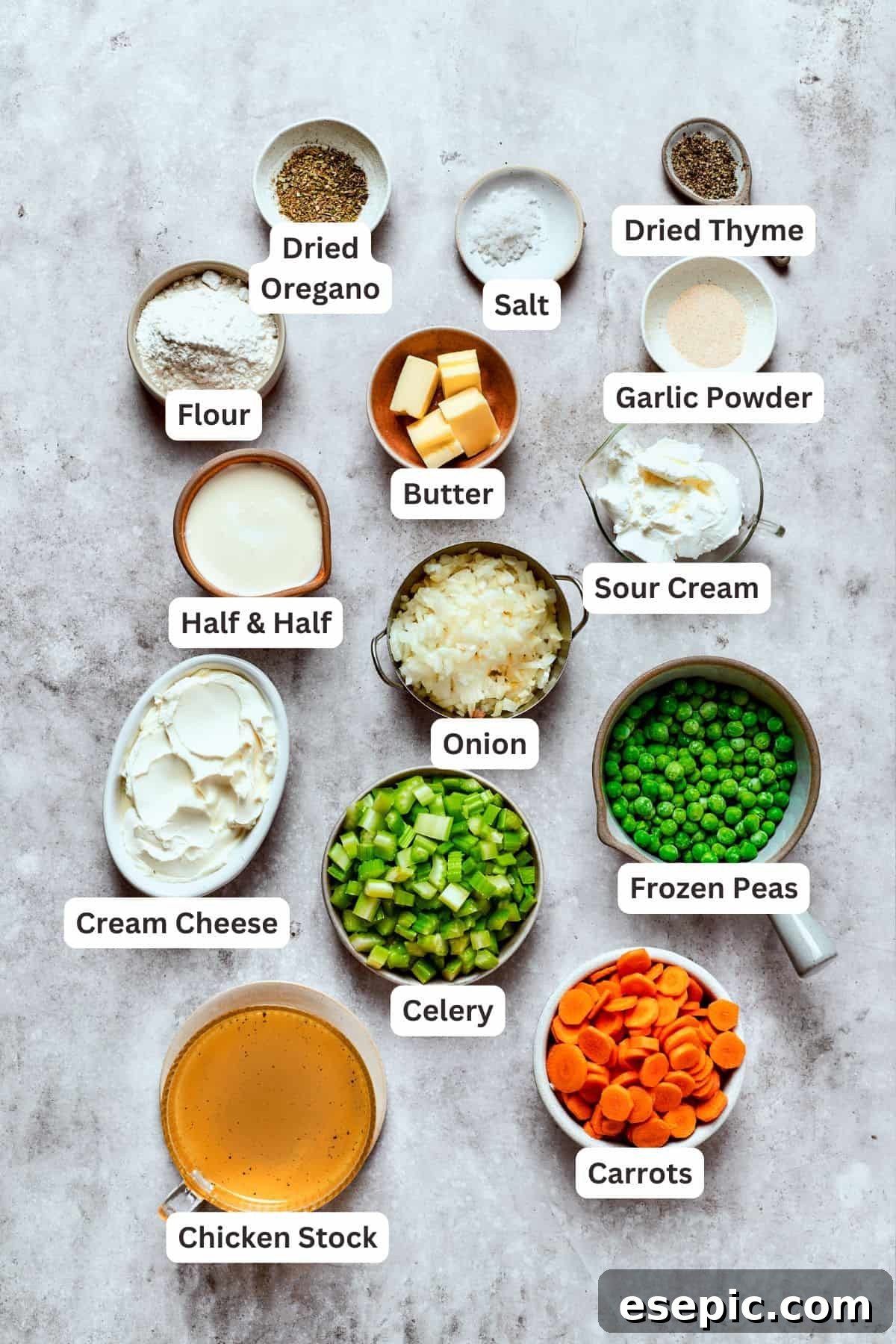 Chicken pot pie casserole is everything you love about the classic comfort food, baked under fluffy buttermilk biscuits instead of pie crust! A collection of fresh ingredients laid out on a wooden board, including carrots, celery, onions, chicken thighs, and various spices, ready for making chicken pot pie filling.