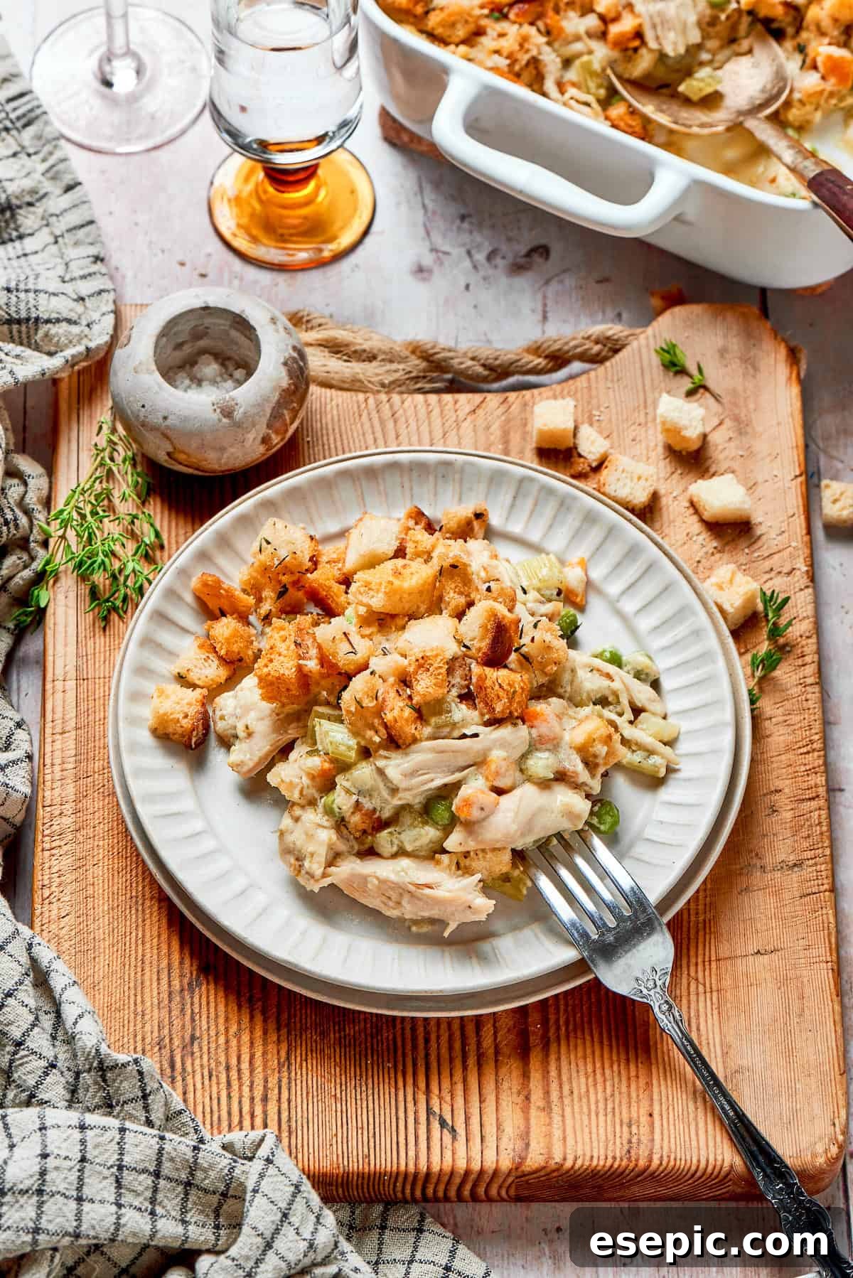 A serving of chicken stuffing casserole on a plate, garnished.