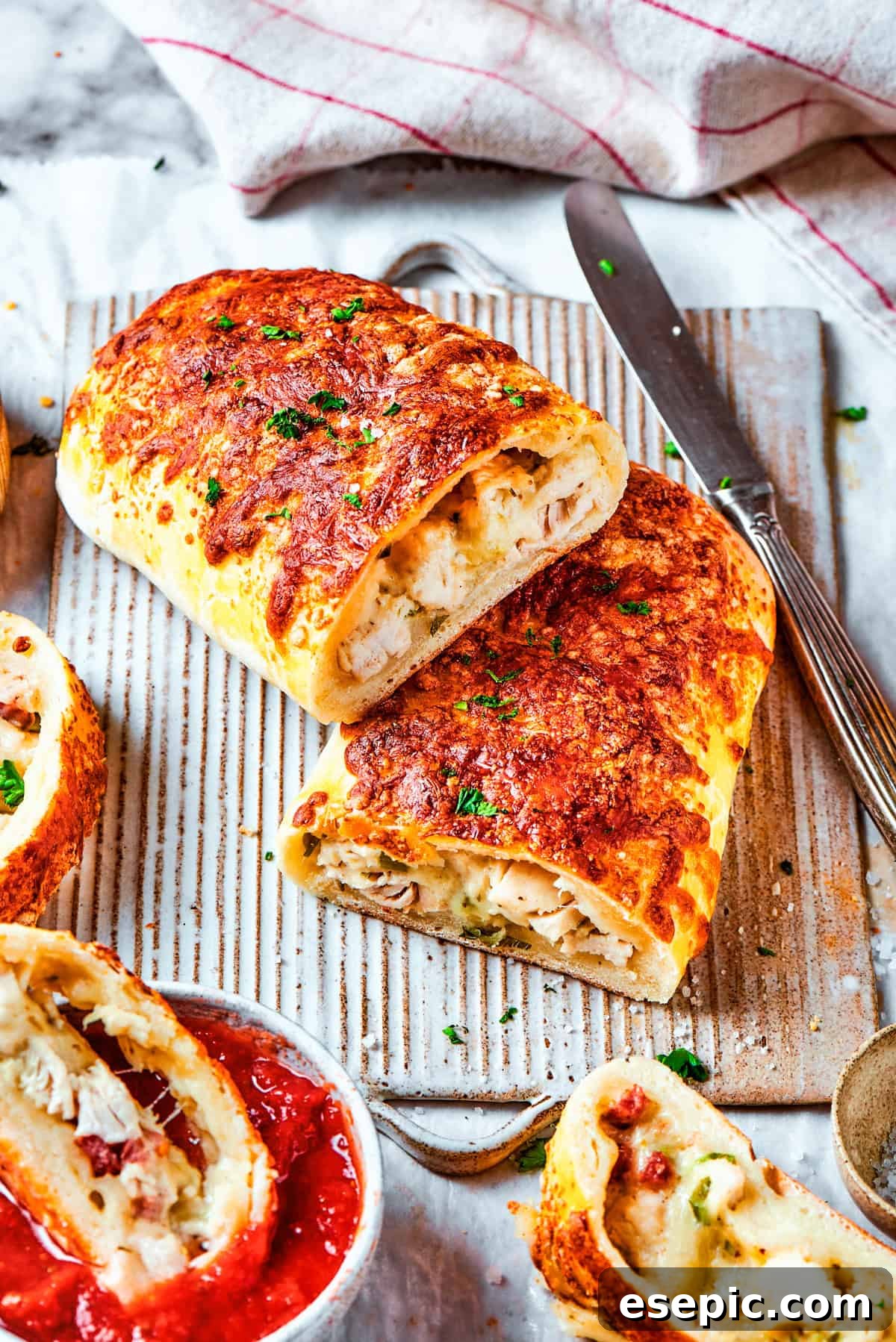 Halved chicken bake sandwiches stacked one on top of the other.