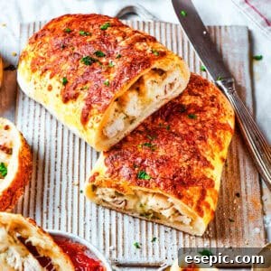 Halved chicken bake sandwiches stacked one on top of the other.