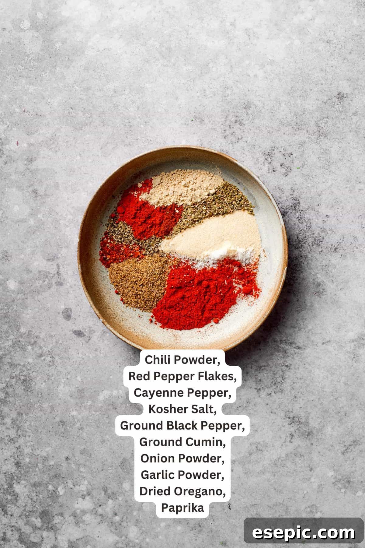 A selection of spices including chili powder, cumin, and paprika, clearly labeled as key seasoning ingredients for Mexican taco spaghetti.