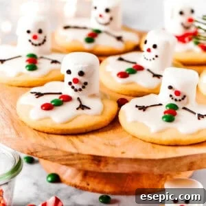 Melted snowman cookies are arranged on a cake plate, ready to be enjoyed.
