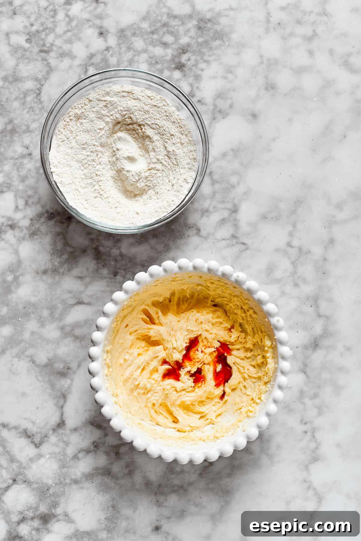 Pouring vanilla extract into cookie dough, infusing it with classic sweet flavor.