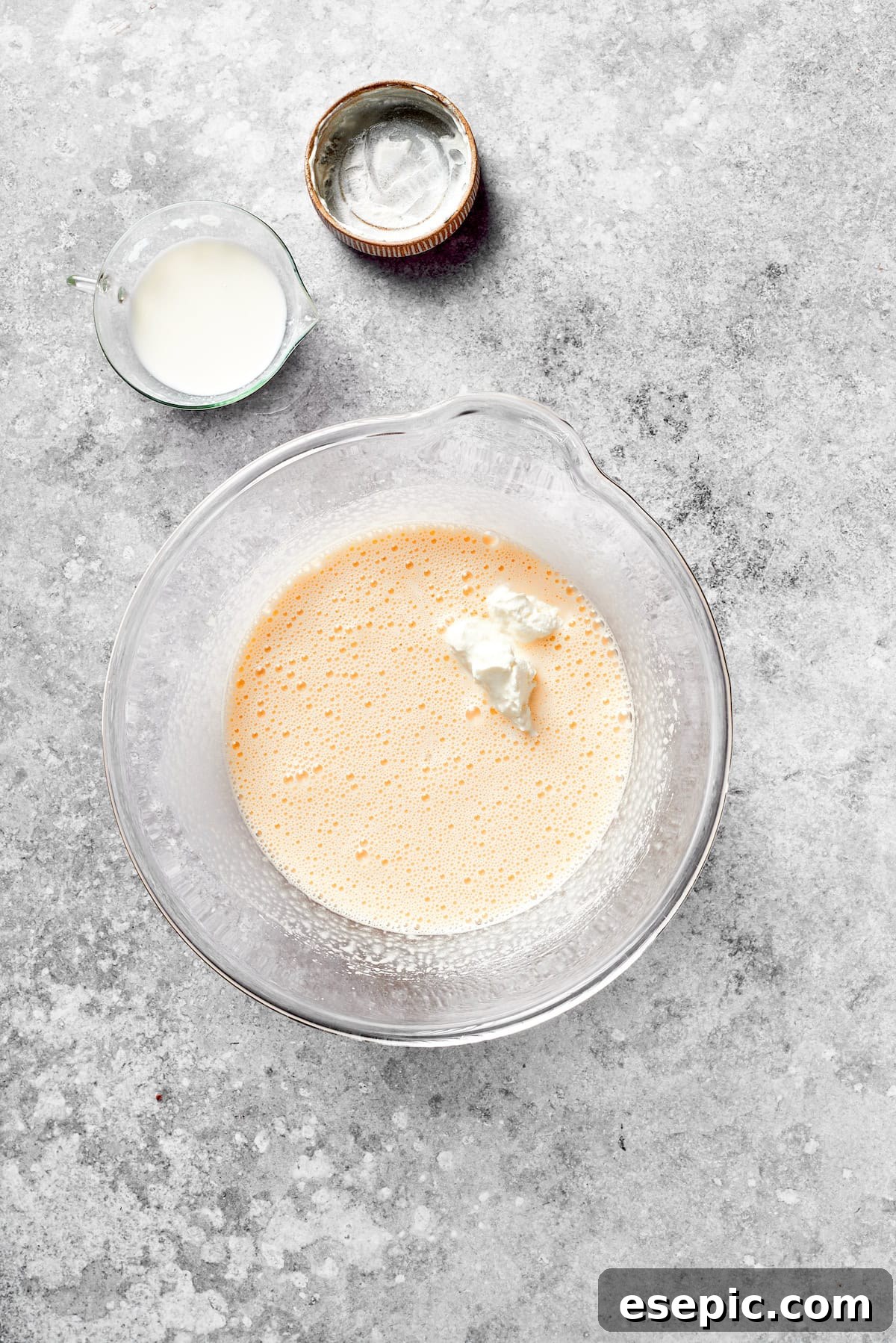 Sour cream is added to the cake batter, enriching the mixture.