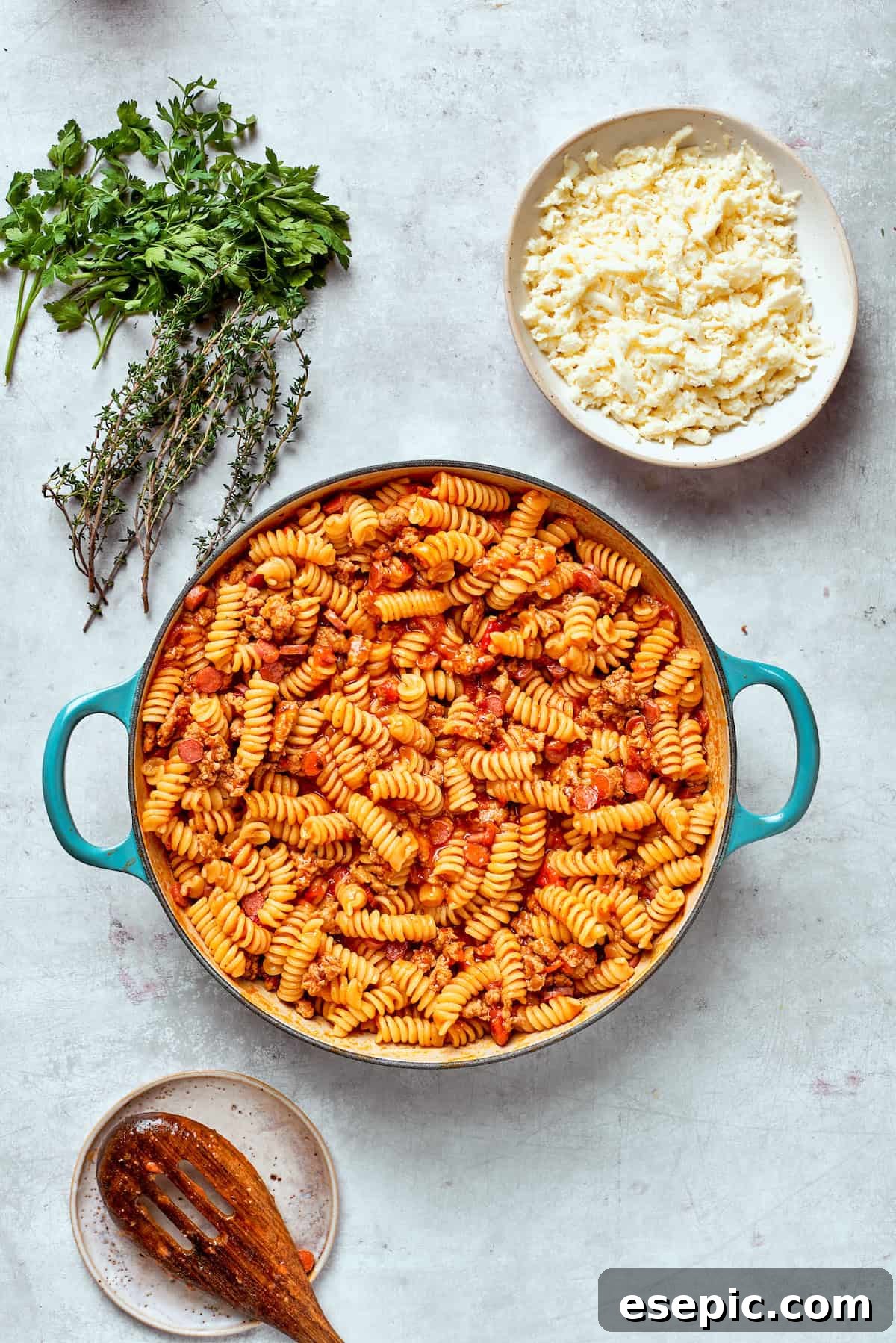 The pasta and sauce wait to be topped with cheese, after cooking until tender.