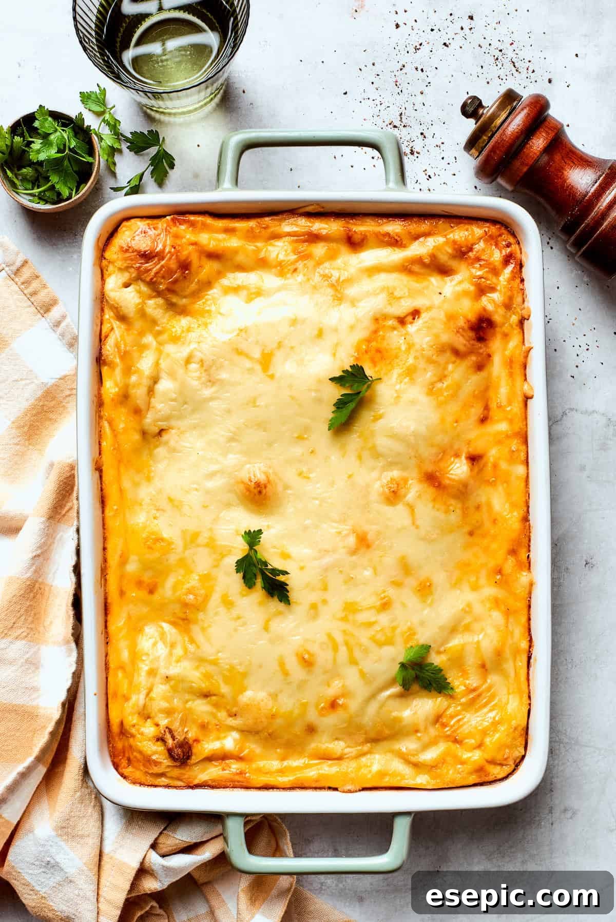 The baked biscuits and gravy casserole, golden brown and bubbly, fresh out of the oven.