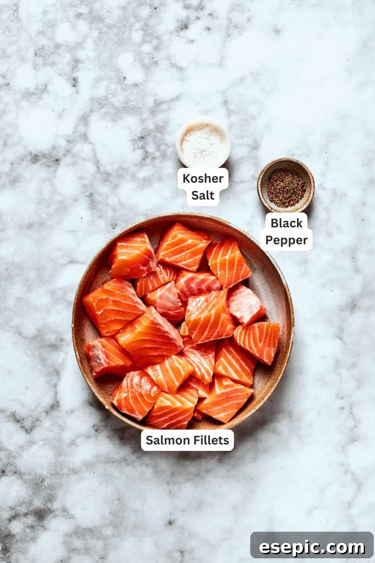 My teriyaki salmon recipe glazes flaky salmon with a homemade sticky-sweet marinade that adds tons of flavor. Salmon fillets, seasoned with salt and pepper, ready for cooking.
