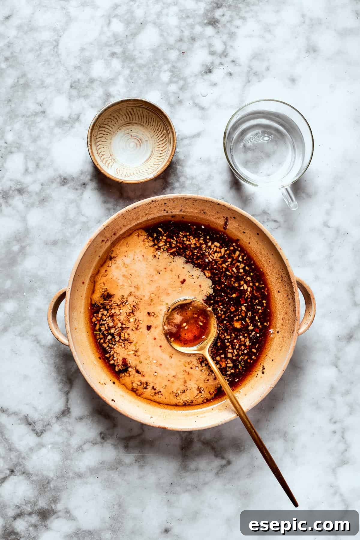 My teriyaki salmon recipe glazes flaky salmon with a homemade sticky-sweet marinade that adds tons of flavor. Teriyaki sauce being whisked vigorously in a bowl until smooth.