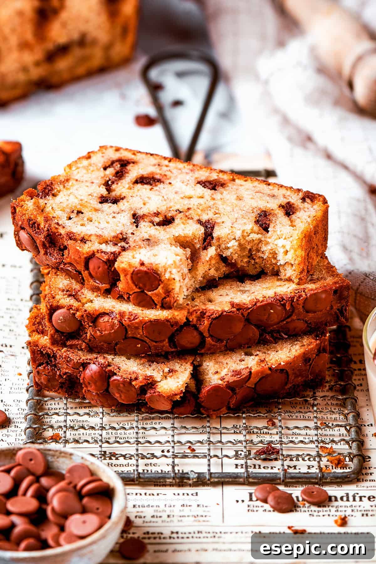 Three slices of banana chocolate chip bread stacked on top of each other.