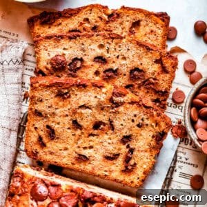 Sliced loaf of banana bread with chocolate chips.