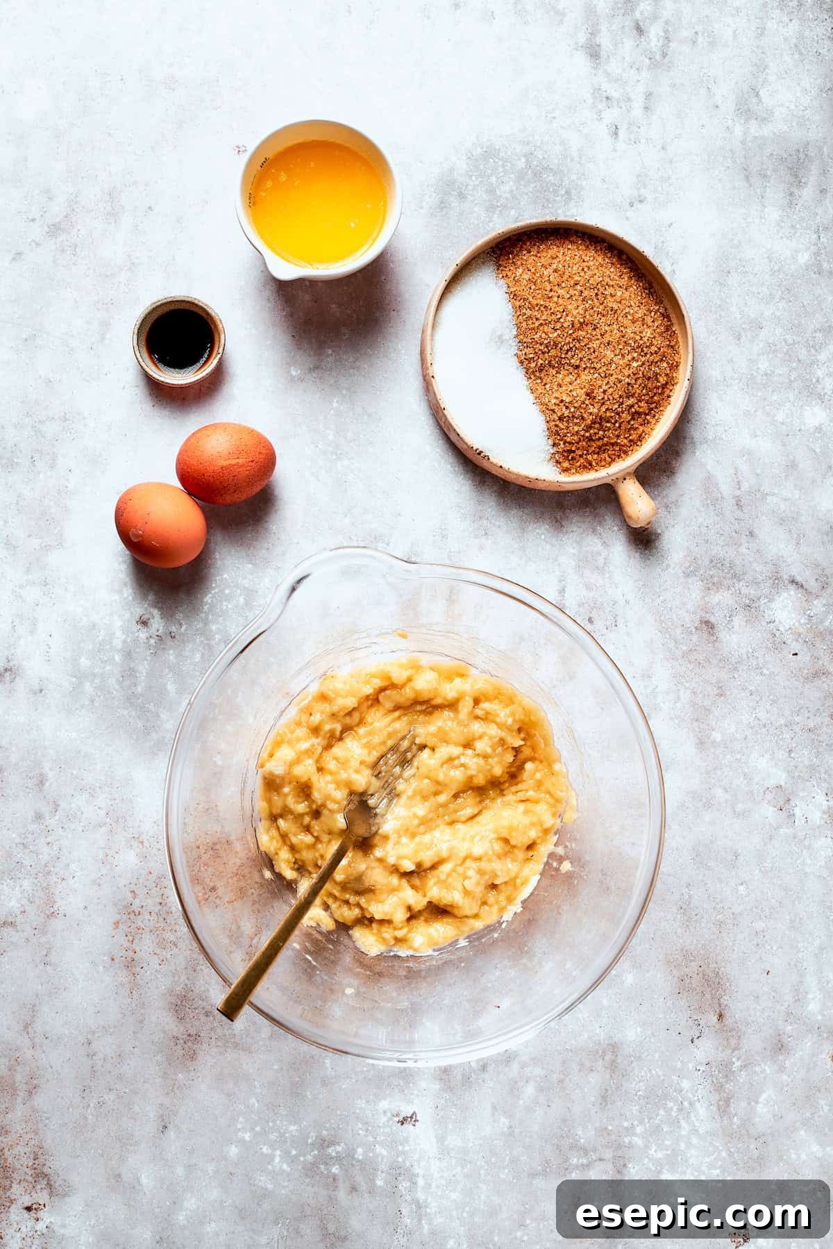 Mashing bananas with a fork in a bowl.