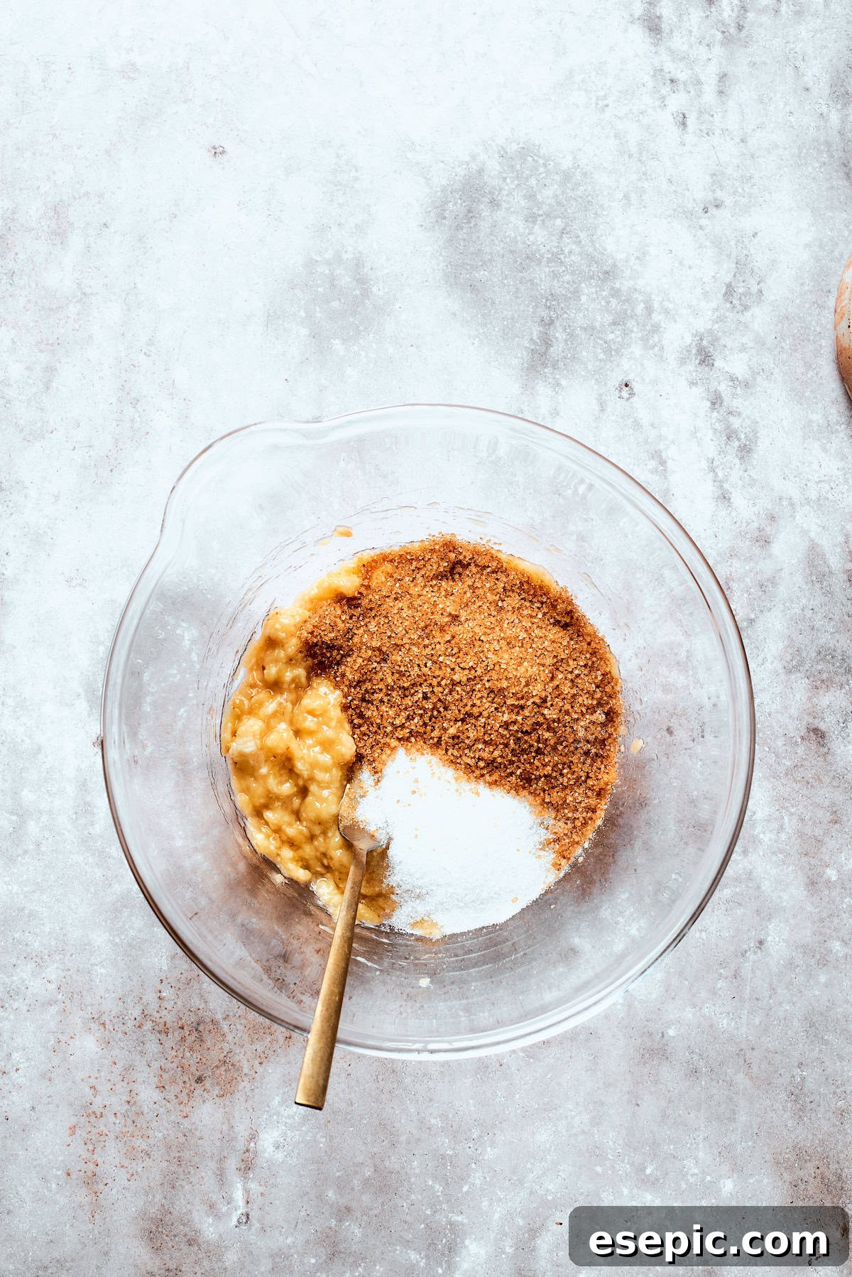 Sugar is added to mashed banana.