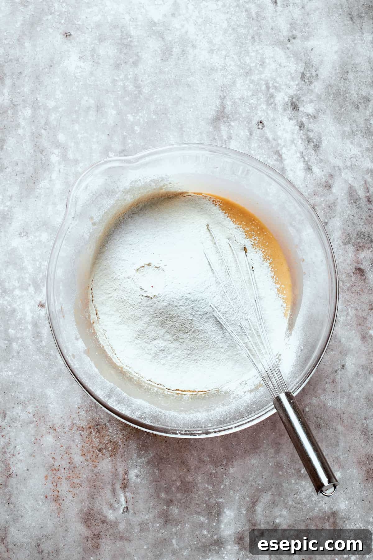 Flour is mixed into banana bread batter.