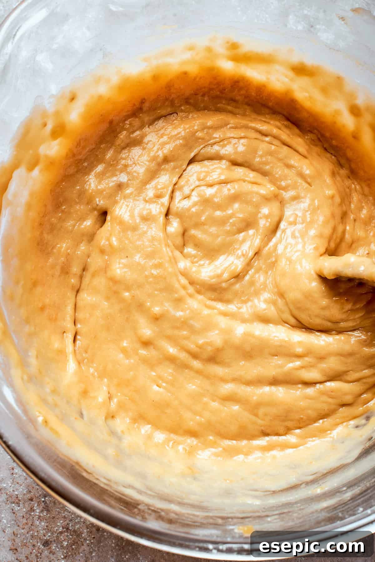 A thick batter for banana bread in a bowl.