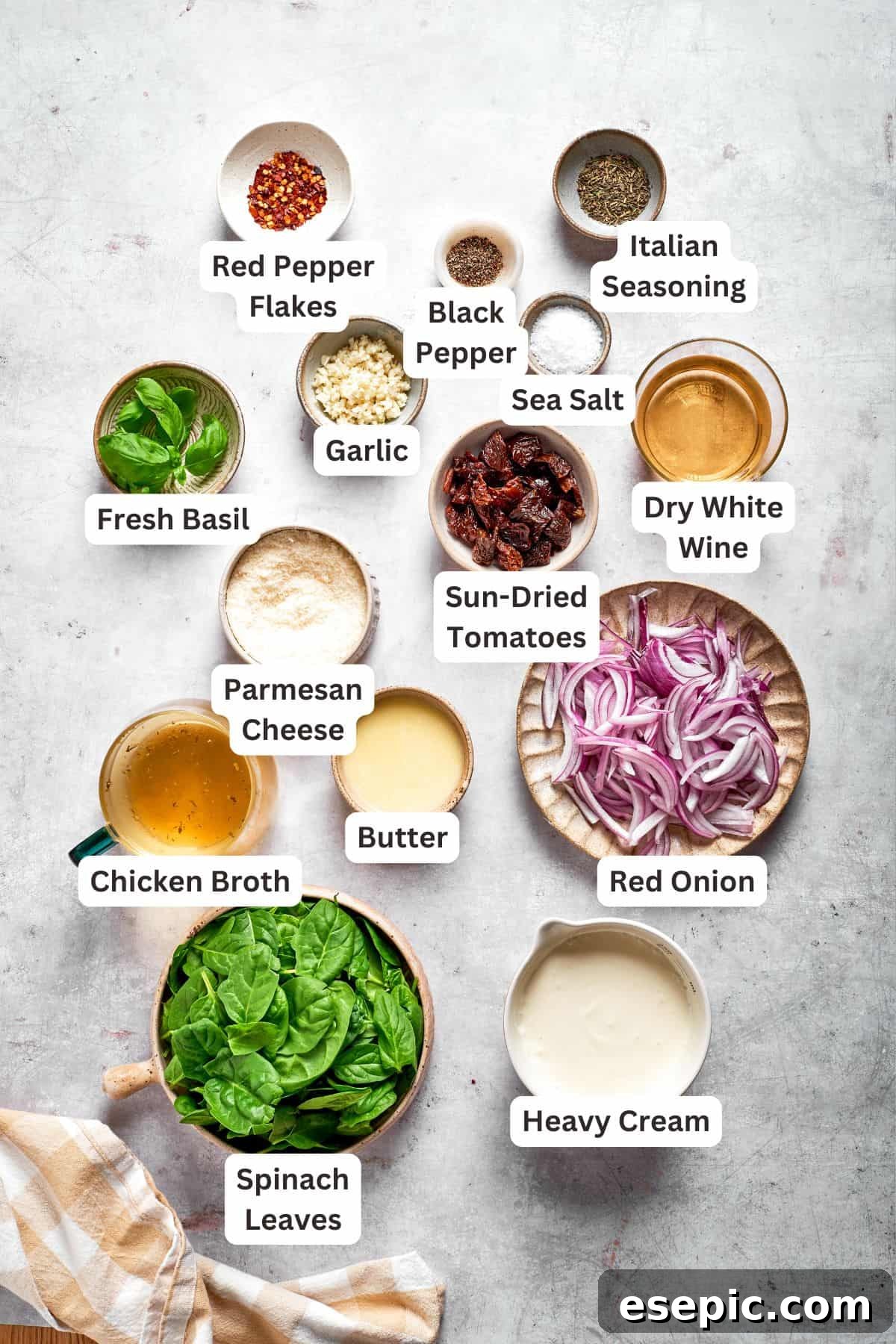 Cheesy, marry me chicken pasta features tender bites of chicken swirled in a creamy sauce along with sundried tomatoes and pasta. The ingredients for marry me chicken pasta are text-labeled.
