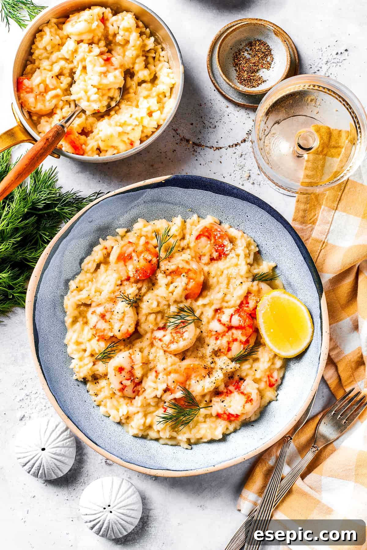 A vibrant serving of creamy shrimp risotto garnished with fresh herbs on a dinner plate.