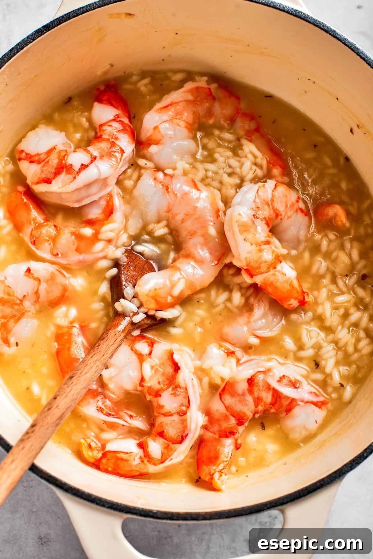 Tender shrimp added to the creamy risotto, cooking until pink and opaque.