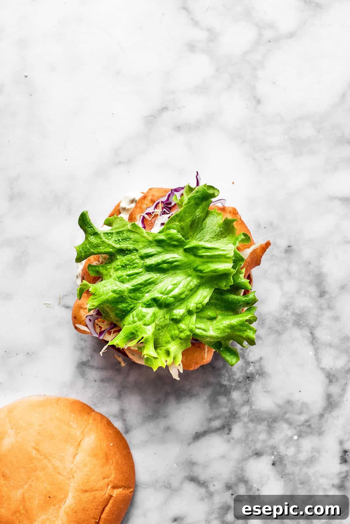 Greens added to a fish sandwich.