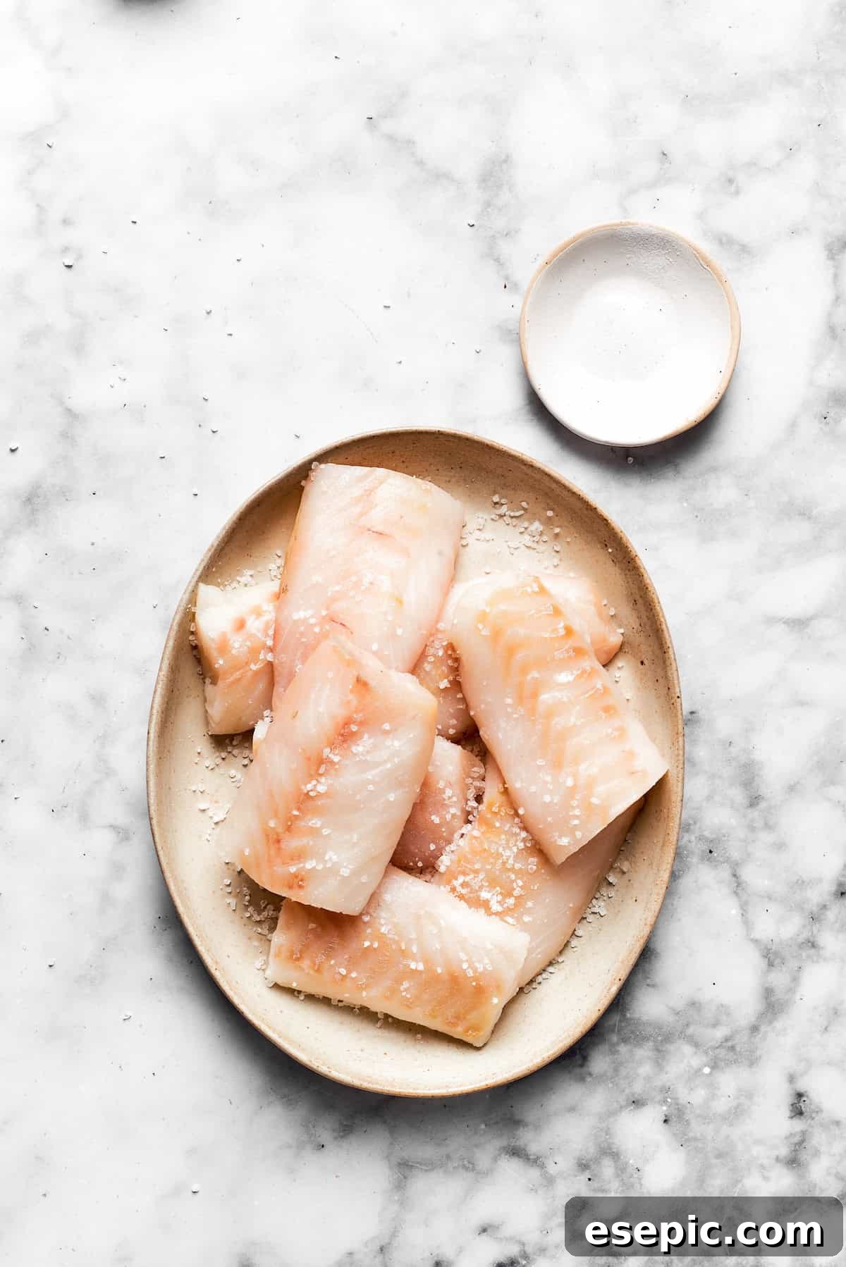 Pieces of white fish on a plate.