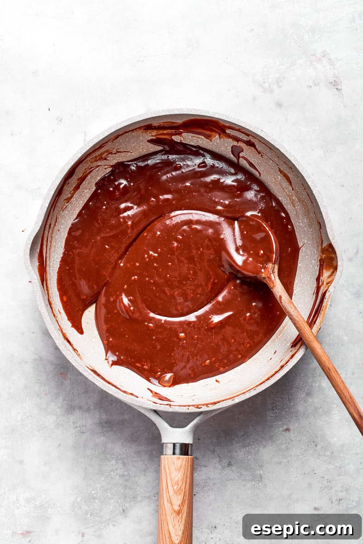 No-bake scotcharoos feature creamy peanut butter, crispy rice cereal, and a sweet layer of melted chocolate and butterscotch. Butterscotch and chocolate chips melting in a bowl over a double boiler.