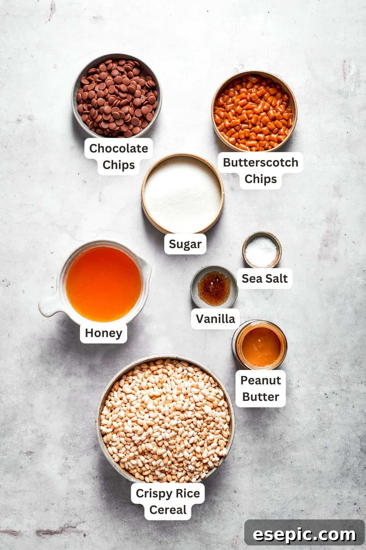 No-bake scotcharoos feature creamy peanut butter, crispy rice cereal, and a sweet layer of melted chocolate and butterscotch. Ingredients for scotcharoos are clearly labeled and laid out.