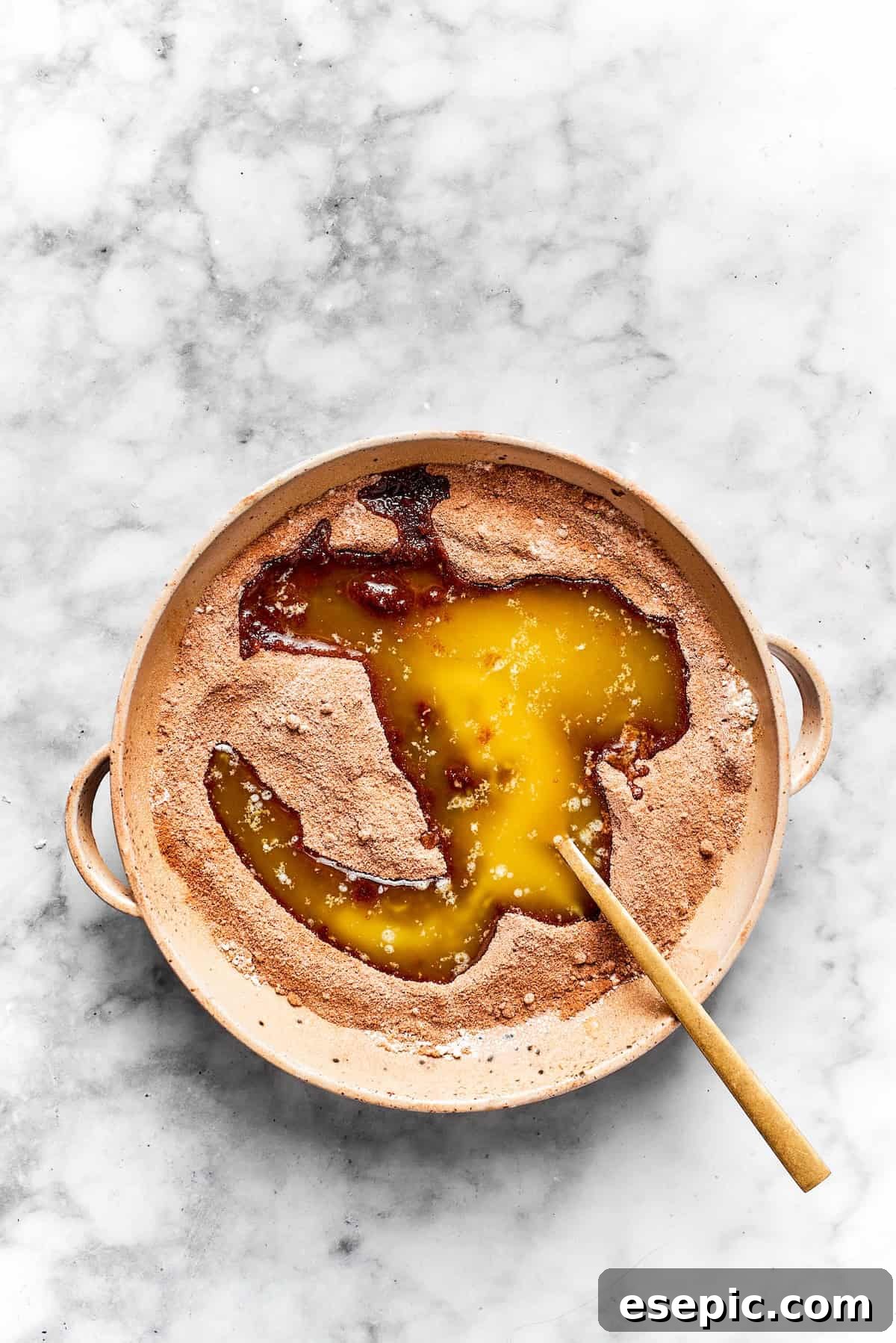 Melted butter is mixed with cinnamon and brown sugar.