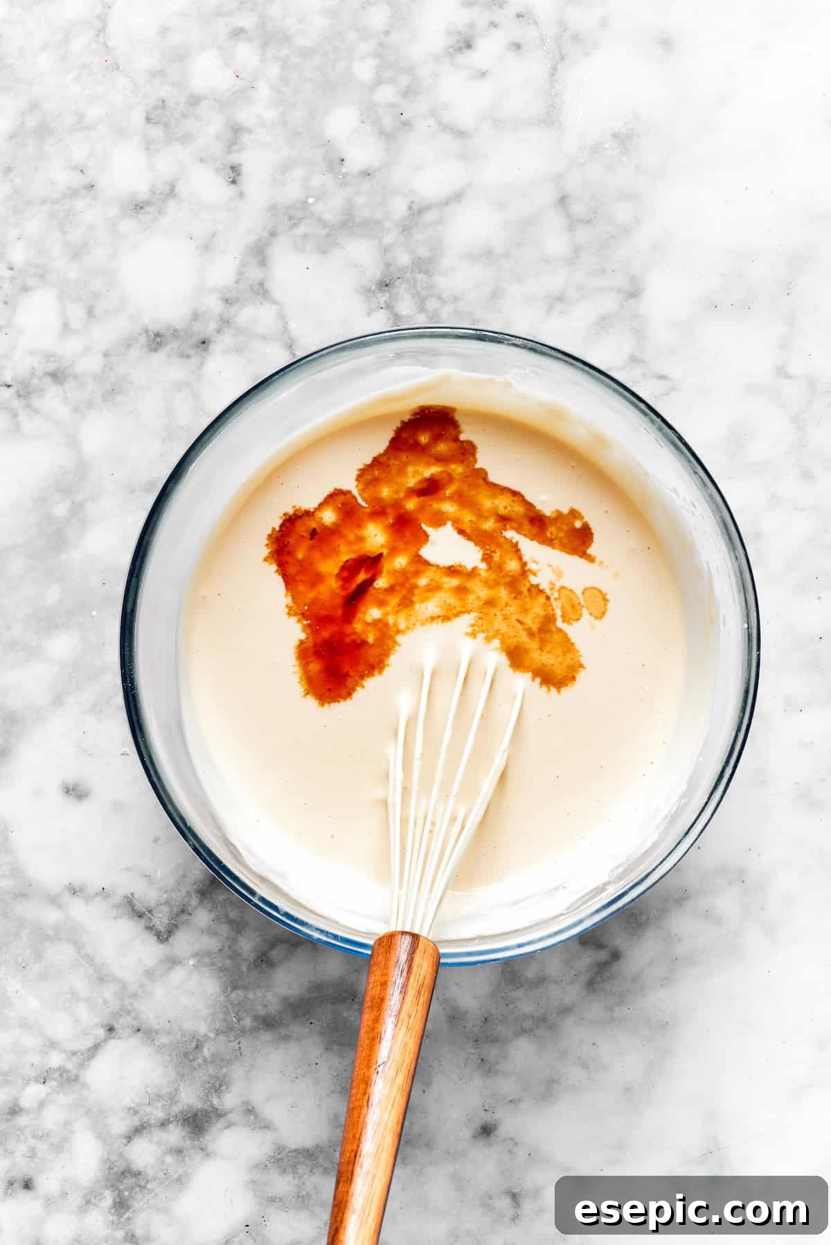 Vanilla is mixed into cinnamon roll cheesecake batter.