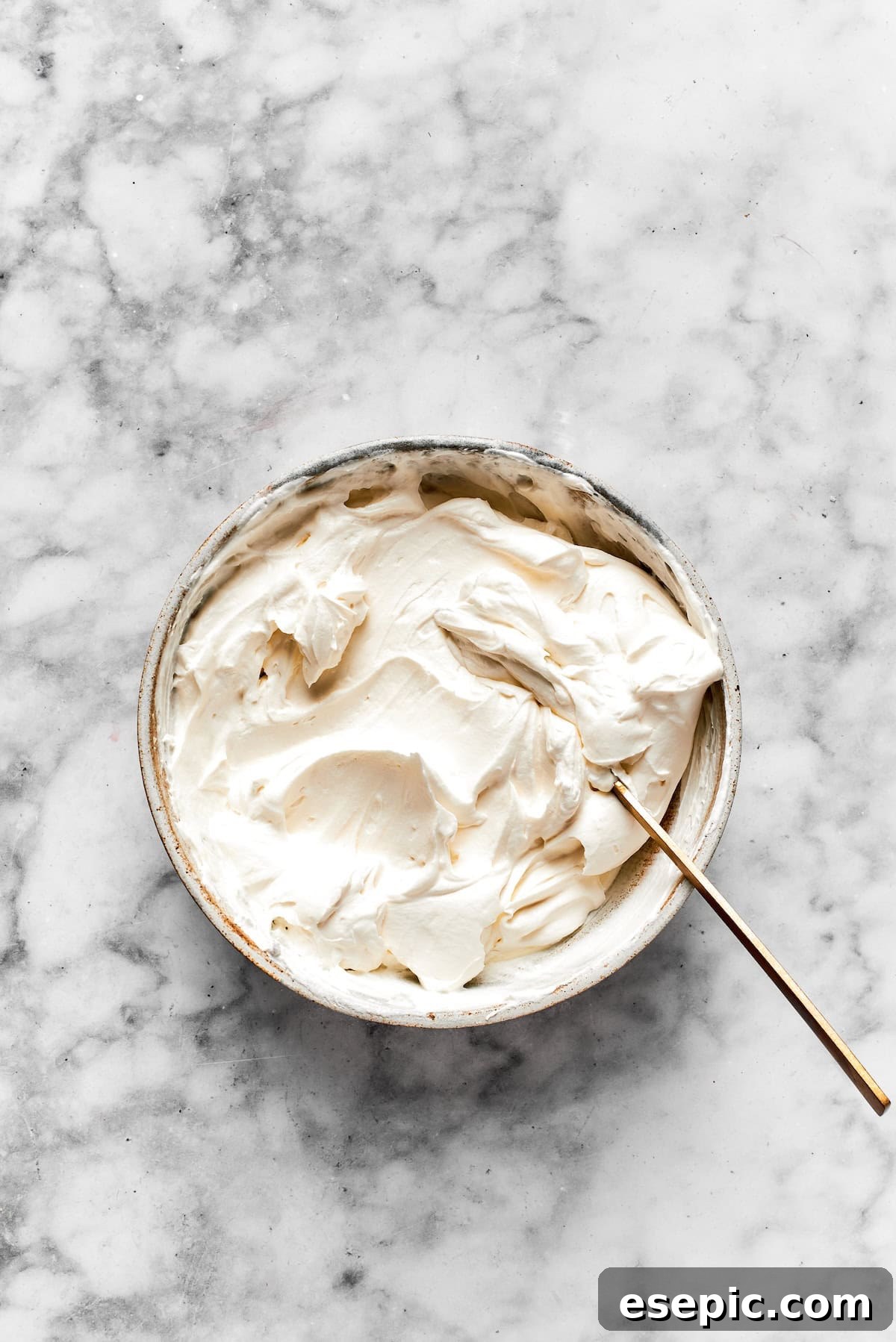Cinnamon roll cheesecake frosting in a bowl.