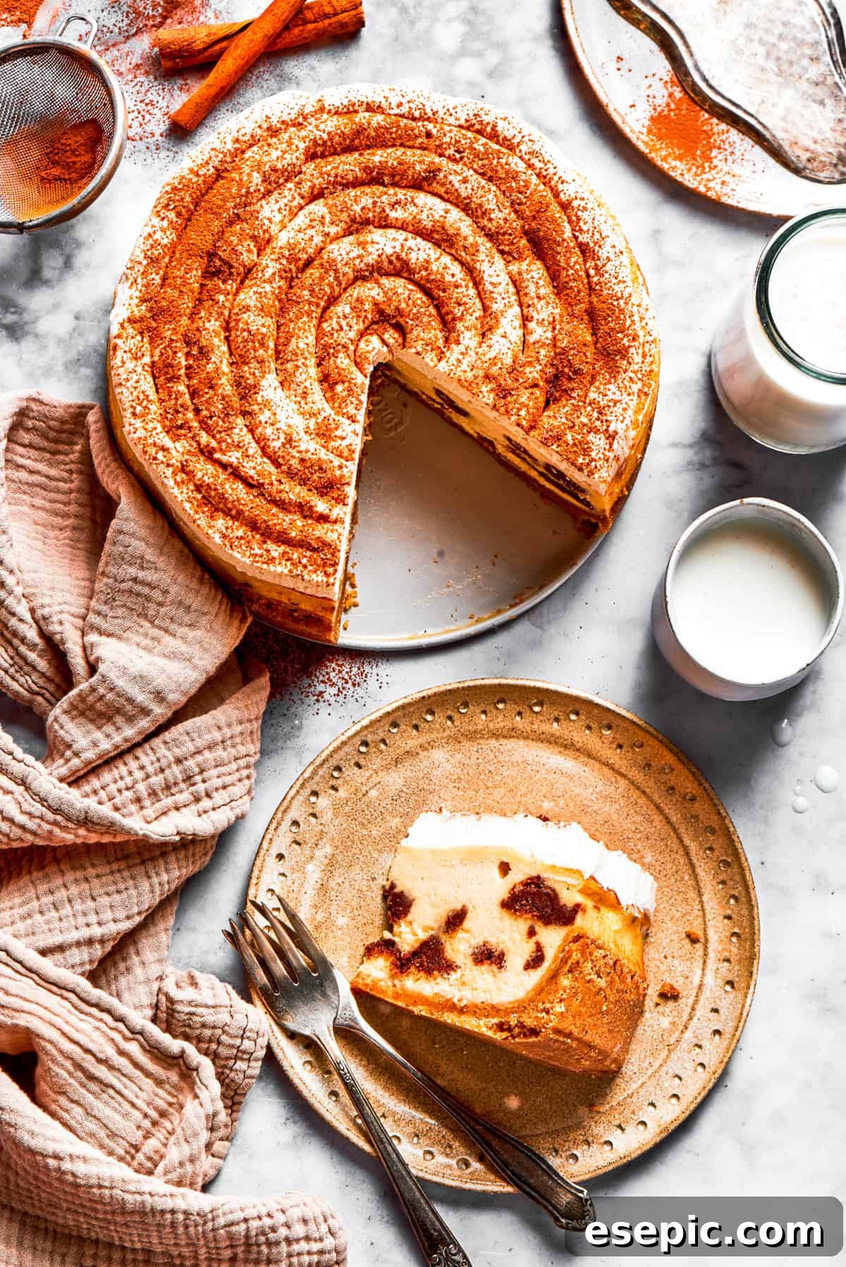 A beautifully frosted cinnamon roll cheesecake, ready for slicing.
