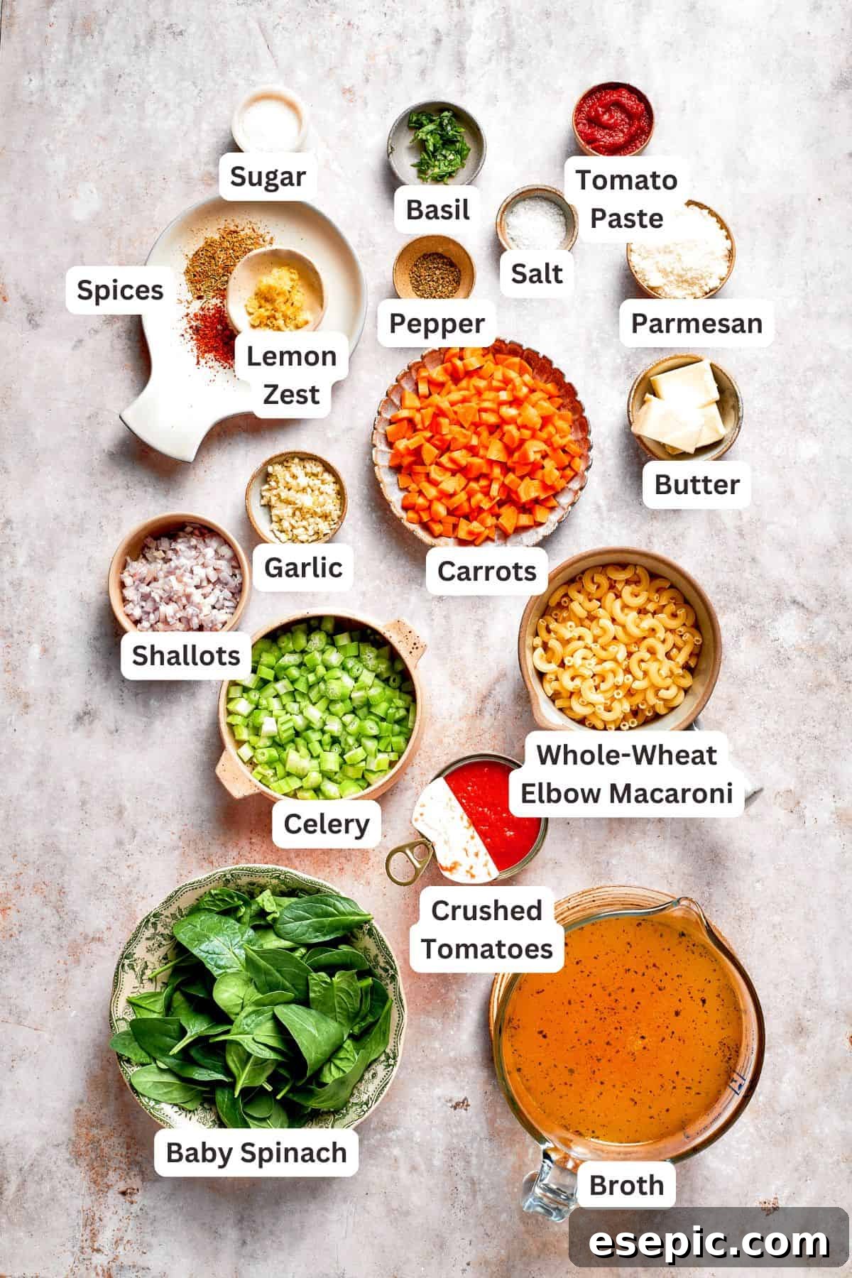 Tomato Florentine soup is deliciously hearty, packed with vegetables, herbs, spinach, and pasta simmered in a tomato-based broth. Ingredients for tomato florentine soup laid out on a wooden board, clearly labeled for easy identification.