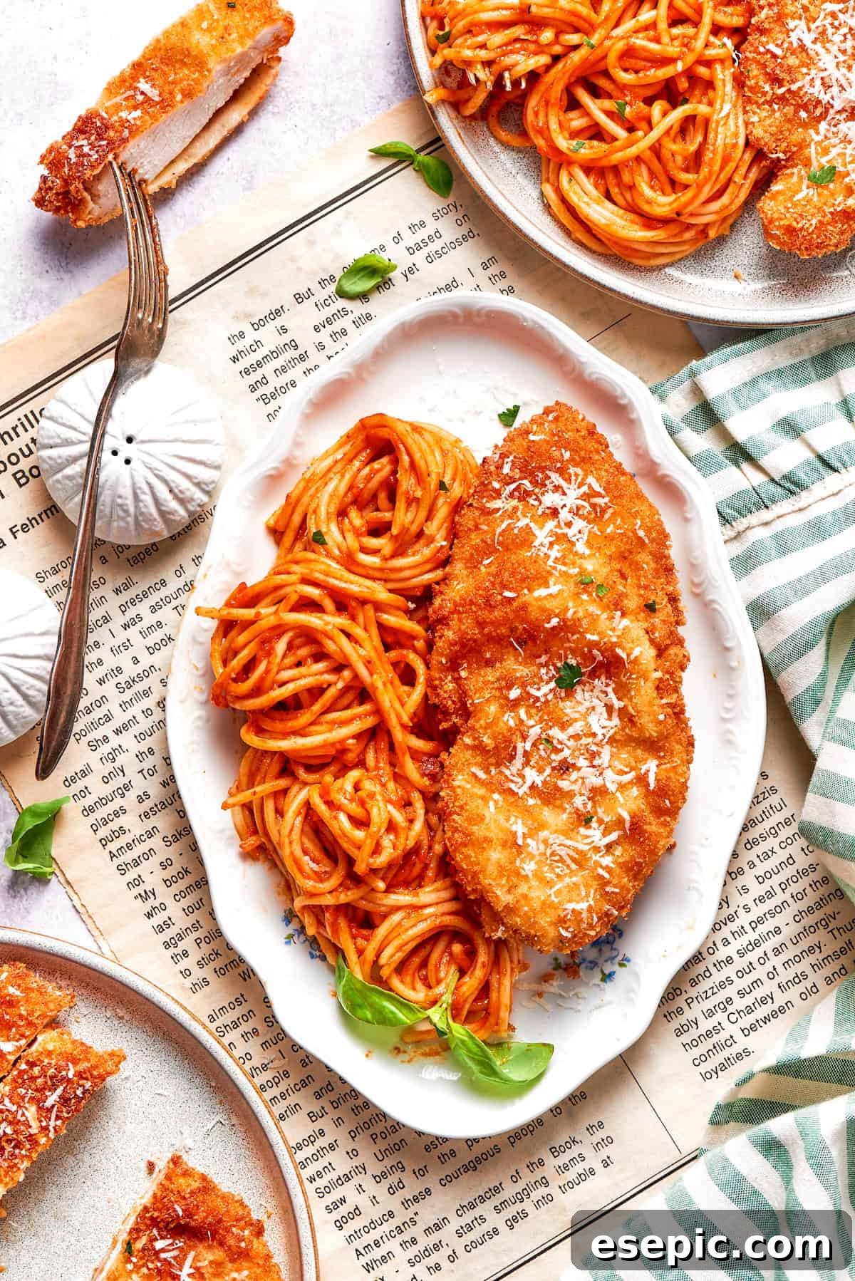 A stunning platter showcasing spaghetti with marinara sauce and perfectly crusted chicken romano.