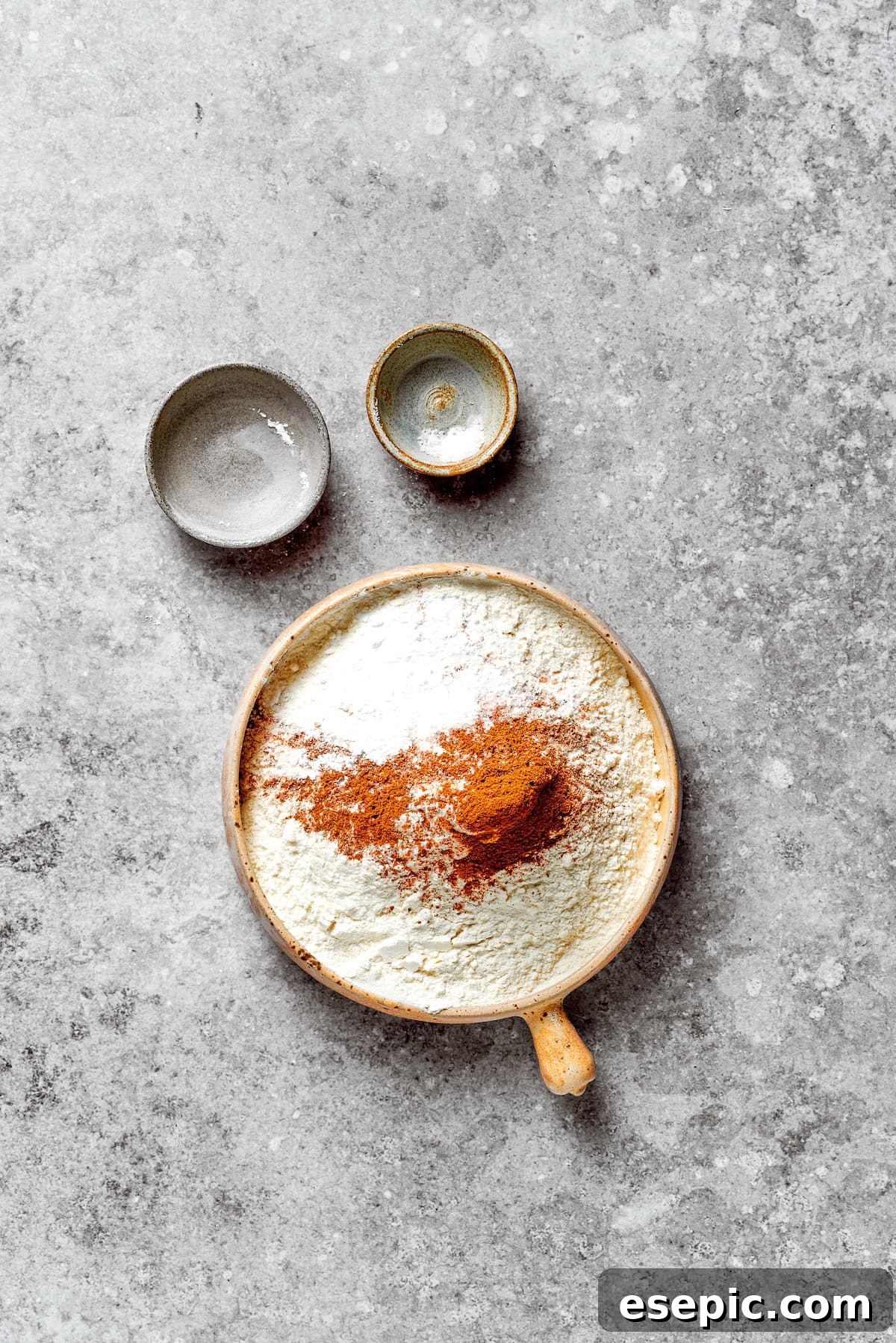 Dry ingredients for the carrot cake, including flour and spices, in a bowl.